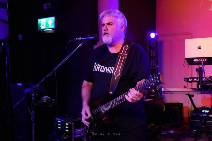 Kromiius guitarist at the microphone at The Space, Isle of Dogs, London